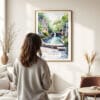 03 - Framed Hot Springs National Park Watercolor Wall Art - In Living Room with Woman Looking at it - Portrait.jpg