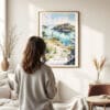 03 - Framed Isle Royale National Park Watercolor Wall Art - In Living Room with Woman Looking at it - Portrait.jpg
