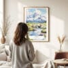 03 - Framed Katmai National Park Watercolor Wall Art - In Living Room with Woman Looking at it - Portrait.jpg