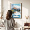 03 - Framed Lake Clark National Park Watercolor Wall Art - In Living Room with Woman Looking at it - Portrait.jpg