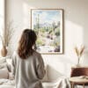 03 - Framed Saguaro National Park Watercolor Wall Art - In Living Room with Woman Looking at it - Portrait.jpg