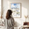 03 - Framed White Sands National Park Watercolor Wall Art - In Living Room with Woman Looking at it - Portrait.jpg