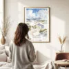 03 - Framed White Sands National Park Watercolor Wall Art - In Living Room with Woman Looking at it - Portrait.jpg