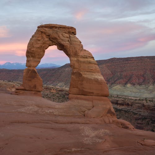 Breathtaking image of the Delicate Arch set against a vibrant sunset in Utah.