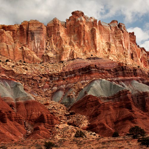 Stunning sandstone rock formation with vibrant layers and blue sky at Capitol Reef National Park.