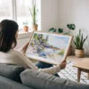 02 - A Woman Holding A Framed Acadia National Park Watercolor - Horizontal Art Print.jpg
