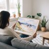02 - A Woman Holding A Framed Cannon Beach Watercolor - Horizontal Art Print.jpg