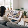 02 - A Woman Holding A Framed NYC Manhattan Bridge Watercolor Art - Horizontal Art Print - Horizontal.jpg