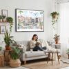 02 - Framed A Morning in Amsterdam Watercolor Art - Horizontal Canvas Print - Boho Living Room with Woman reading.jpg