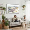 02 - Framed Badlands National Park Watercolor - Horizontal Canvas Print - Boho Living Room with Woman reading.jpg