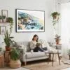 02 - Framed Big Sur Watercolor - Horizontal Canvas Print - Boho Living Room with Woman reading.jpg