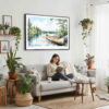 02 - Framed Boundary Waters Watercolor - Horizontal Canvas Print - Boho Living Room with Woman reading.jpg