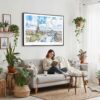 02 - Framed Paris Skyline Watercolor Art - Horizontal Canvas Print - Boho Living Room with Woman reading.jpg