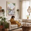 03 - Framed Morning Coffee in Amsterdam Watercolor Art Print - In Bohi Living Room with Woman reading - Vertical.jpg