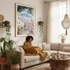 03 - Framed Morning Coffee in Lisbon Watercolor Art Print - In Bohi Living Room with Woman reading - Vertical.jpg