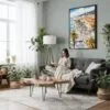 02 - Framed Nice French Riviera Watercolor Canvas Print - Woman reading in Boho Living Room - Vertical.jpg