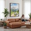 02 - Framed Rocky Mountains Watercolor Canvas Print - Woman Knitting on leather couch - Vertical.jpg