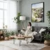 02 - Framed Theodore Roosevelt National Park Watercolor Canvas Print - Woman reading in Boho Living Room - Vertical.jpg