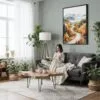 02 - Framed White Mountains New Hampshire Watercolor Canvas Print - Woman reading in Boho Living Room - Vertical.jpg