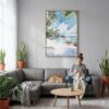02 - Hawaii - Watercolor Canvas Print with Natural Floater Frame - Woman Knitting on grey couch - Vertical.jpg