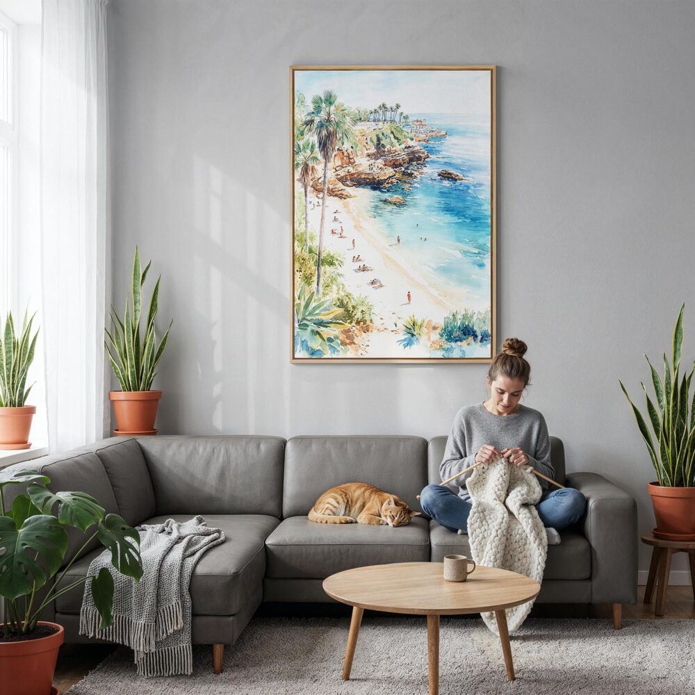 02 - La Jolla Cove Watercolor Canvas Print with Natural Floater Frame - Woman Knitting on grey couch - Vertical.jpg 02 - La Jolla Cove Watercolor Canvas Print with Natural Floater Frame - Woman Knitting on grey couch - Vertical.jpg