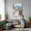 02 - Medellin Old Town Watercolor Canvas Print with Natural Floater Frame - Woman Knitting on grey couch - Vertical.jpg