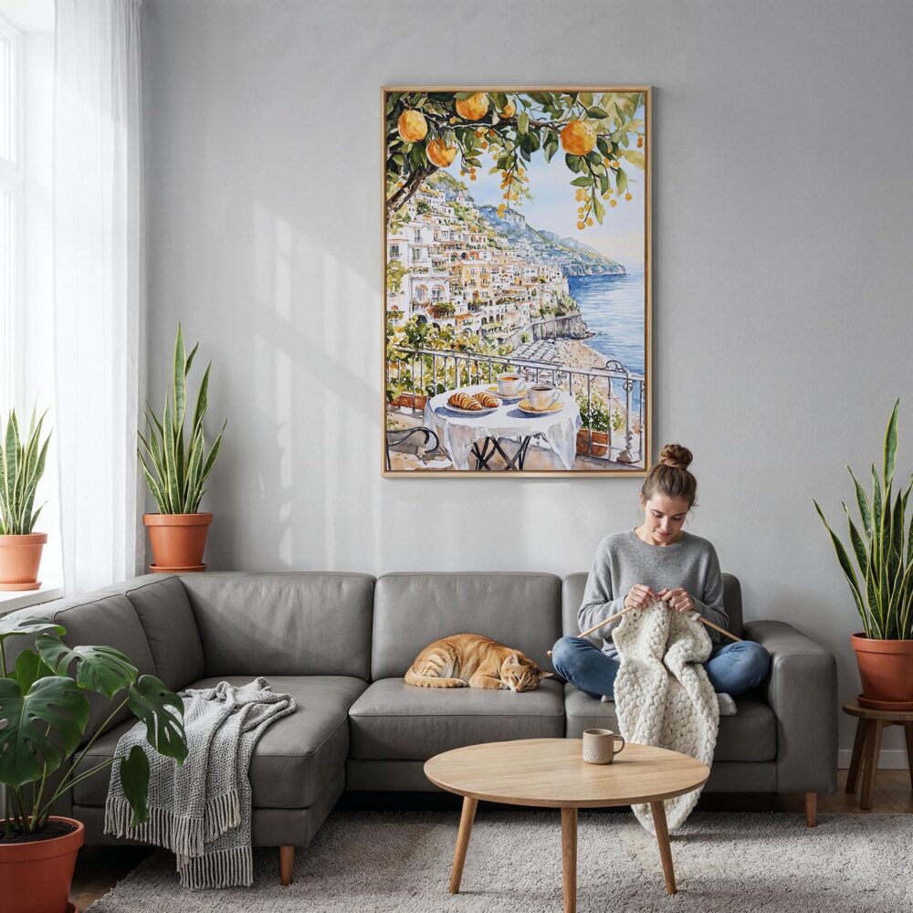 02 - Morning Coffee in Amalfi Coast Watercolor Canvas Print with Natural Floater Frame - Woman Knitting on grey couch - Vertical.jpg 02 - Morning Coffee in Amalfi Coast Watercolor Canvas Print with Natural Floater Frame - Woman Knitting on grey couch - Vertical.jpg