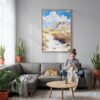 02 - Petrified Forest National Park Watercolor Canvas Print with Natural Floater Frame - Woman Knitting on grey couch - Vertical.jpg