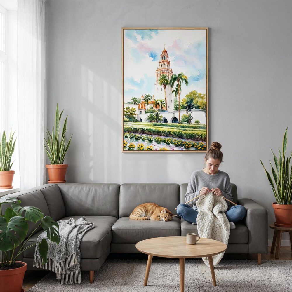 03 - Balboa Park California Tower Watercolor Canvas Print with Natural Floater Frame - Woman Knitting on grey couch - Vertical.jpg 03 - Balboa Park California Tower Watercolor Canvas Print with Natural Floater Frame - Woman Knitting on grey couch - Vertical.jpg