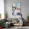 03 - Brooklyn Bridge - Watercolor Canvas Print with Natural Floater Frame - Woman Knitting on grey couch - Vertical.jpg