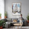 03 - Flatiron Watercolor Canvas Print with Natural Floater Frame - Woman Knitting on grey couch - Vertical.jpg