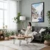 03 - Framed Bourbon Street New Orleans Watercolor Canvas Print - Woman reading in Boho Living Room - Vertical.jpg