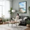 03 - Framed California Laguna Beach Watercolor Canvas Print - Woman reading in Boho Living Room - Vertical.jpg
