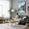 03 - Framed Hawaii - Nā Pali Watercolor Canvas Print - Woman reading in Boho Living Room - Vertical.jpg
