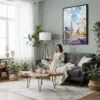 03 - Framed Las Vegas Watercolor Canvas Print - Woman reading in Boho Living Room - Vertical.jpg
