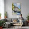 03 - Lauterbrunnen Switzerland Watercolor Canvas Print with Natural Floater Frame - Woman Knitting on grey couch - Vertical.jpg