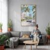 03 - Miami Watercolor Canvas Print with Natural Floater Frame - Woman Knitting on grey couch - Vertical.jpg