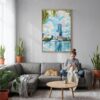 03 - Orlando Florida Watercolor Canvas Print with Natural Floater Frame - Woman Knitting on grey couch - Vertical.jpg