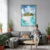 03 - The Bahamas Islands watercolor Canvas Print with Natural Floater Frame - Woman Knitting on grey couch - Vertical.jpg