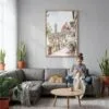 04 - Florence Cathedral - Watercolor Canvas Print with Natural Floater Frame - Woman Knitting on grey couch - Vertical.jpg