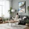 04 - Framed Acadia National Park Watercolor Canvas Print - Woman reading in Boho Living Room - Vertical.jpg