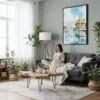 04 - Framed Amritsar Golden Temple Watercolor Canvas Print - Woman reading in Boho Living Room - Vertical.jpg