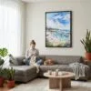 04 - Framed Laguna Beach Coast Watercolor Canvas Print - Woman Knitting on grey couch - Vertical.jpg
