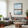 04 - Framed Los Angeles Waterfront Homes Watercolor Canvas Print - Woman Knitting on grey couch - Vertical.jpg
