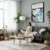 04 - Framed Niagara Falls Watercolor Canvas Print - Woman reading in Boho Living Room - Vertical.jpg