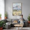 04 - Grand Teton Watercolor Canvas Print with Natural Floater Frame - Woman Knitting on grey couch - Vertical.jpg