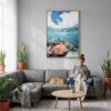 04 - Great Barrier Reef Watercolor Canvas Print with Natural Floater Frame - Woman Knitting on grey couch - Vertical.jpg