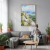 04 - Great Basin Watercolor Canvas Print with Natural Floater Frame - Woman Knitting on grey couch - Vertical.jpg
