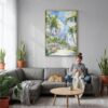 04 - Miami Beach Watercolor Canvas Print with Natural Floater Frame - Woman Knitting on grey couch - Vertical.jpg