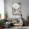 04 - Morning Coffee in Amsterdam Watercolor Canvas Print with Natural Floater Frame - Woman Knitting on grey couch - Vertical.jpg